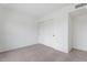 Carpeted bedroom has a sliding closet with white doors and neutral walls at 2741 E Sweetwater Ave, Phoenix, AZ 85032