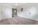 A carpeted bedroom has a sliding glass door, a closet, and fresh, white paint at 2741 E Sweetwater Ave, Phoenix, AZ 85032