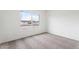 A carpeted bedroom has a view of a house across the street from its window at 2741 E Sweetwater Ave, Phoenix, AZ 85032