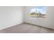 Carpeted bedroom with a large window offering a pleasant exterior view at 2741 E Sweetwater Ave, Phoenix, AZ 85032