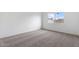 Bedroom featuring fresh white paint, neutral carpeting, and a window with a view at 2741 E Sweetwater Ave, Phoenix, AZ 85032