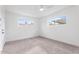 A bright bedroom has two windows with a view and neutral carpet at 2741 E Sweetwater Ave, Phoenix, AZ 85032
