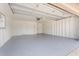 Spacious two car garage with painted walls and floor and multiple access doors at 2741 E Sweetwater Ave, Phoenix, AZ 85032
