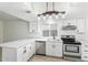 Updated kitchen with stainless steel appliances, white cabinets, and stylish tile flooring at 2741 E Sweetwater Ave, Phoenix, AZ 85032