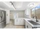 Modern kitchen featuring white cabinets, stainless steel appliances, and tiled flooring at 2741 E Sweetwater Ave, Phoenix, AZ 85032