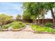 Lush backyard garden featuring vibrant flowers and a charming stone pathway at 2816 S Don Luis Cir, Mesa, AZ 85202