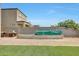 A spacious backyard with garden, stainless steel grill and large grassy area at 30683 W Amelia Ave, Buckeye, AZ 85396