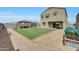 A backyard features a grassy area, patio dining and a gazebo with lounge seating at 30683 W Amelia Ave, Buckeye, AZ 85396