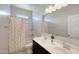 Bathroom with double sink vanity, shower and tub combination and a window for natural light at 30683 W Amelia Ave, Buckeye, AZ 85396