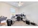 Bedroom with carpet, ceiling fan, and desk setup for an office at 30683 W Amelia Ave, Buckeye, AZ 85396