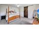 Primary bedroom with carpet, ceiling fan, and wood-style sliding barn door at 30683 W Amelia Ave, Buckeye, AZ 85396