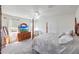 Serene bedroom featuring a four-poster bed, cozy sitting chair, and ample natural light for a relaxing ambiance at 30683 W Amelia Ave, Buckeye, AZ 85396