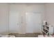 Bright bedroom with two closet doors and a bookshelf filled with books and decor at 30683 W Amelia Ave, Buckeye, AZ 85396