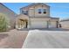 Two story home featuring a two-car garage, manicured landscaping, and a welcoming covered front porch at 30683 W Amelia Ave, Buckeye, AZ 85396