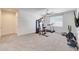 Spacious gym features carpeted floors, a modern ceiling fan, a window and exercise equipment at 30683 W Amelia Ave, Buckeye, AZ 85396