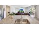 Bright living area with an open view to the kitchen, featuring a comfortable leather sofa and a seamless indoor-outdoor flow at 30683 W Amelia Ave, Buckeye, AZ 85396