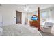 Charming bedroom with a four-poster bed, wooden dresser, and sliding barn door, creating a cozy and inviting space at 30683 W Amelia Ave, Buckeye, AZ 85396