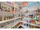 Organized pantry featuring ample shelving stocked with various food items and containers for optimal storage at 30683 W Amelia Ave, Buckeye, AZ 85396