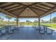 Spacious picnic area under a covered pavilion with tables overlooking the lush community park at 30683 W Amelia Ave, Buckeye, AZ 85396