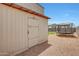A backyard shed is next to a trampoline with a manicured lawn in view at 30683 W Amelia Ave, Buckeye, AZ 85396