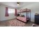 Bedroom featuring a bunk bed, plush pink rug, and ample natural light at 3413 W Ocotillo Rd, Phoenix, AZ 85017