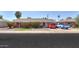 Charming red brick home featuring manicured front yard, tidy landscaping, and a cozy covered porch at 3413 W Ocotillo Rd, Phoenix, AZ 85017