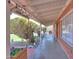 Inviting covered porch with string lights, ideal for relaxing, and offering a view of the landscaped yard at 3413 W Ocotillo Rd, Phoenix, AZ 85017