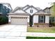 Charming single Gathering home features a two-car garage and manicured front lawn at 3435 E Amber Ln, Gilbert, AZ 85296