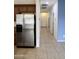 Stainless steel refrigerator in kitchen with hallway view at 3435 E Amber Ln, Gilbert, AZ 85296