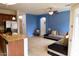 Open-concept living space with tile flooring, ceiling fan, and large windows for natural light at 3435 E Amber Ln, Gilbert, AZ 85296