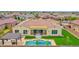 Aerial view of a home featuring a backyard oasis with a pool, lounge area, and beautifully landscaped yard at 3842 E Fountain St, Mesa, AZ 85205