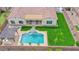 Drone shot of a backyard featuring a luxurious pool, landscaped yard, and comfortable outdoor lounge area at 3842 E Fountain St, Mesa, AZ 85205