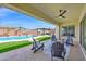 Relaxing back patio area, complete with comfortable seating and view of the backyard oasis at 3842 E Fountain St, Mesa, AZ 85205