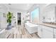 Luxurious bathroom featuring a soaking tub, walk-in shower, and elegant tile flooring at 3842 E Fountain St, Mesa, AZ 85205