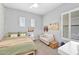 Neutral bedroom offering a cozy couch, decorative pillows, and sun-filled windows at 3842 E Fountain St, Mesa, AZ 85205