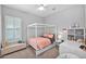 Bright bedroom featuring a four-poster bed, neutral walls and shuttered windows at 3842 E Fountain St, Mesa, AZ 85205