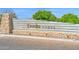 Community entrance sign, Troonita Norte, featuring stacked stone, trees, and decorative landscaping at 3842 E Fountain St, Mesa, AZ 85205