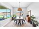 Bright dining area with a view to the backyard pool, complemented by stylish decor and natural light at 3842 E Fountain St, Mesa, AZ 85205
