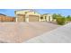 Attractive Southwestern-style home with a three-car garage, paved driveway, and low-maintenance desert landscaping at 3842 E Fountain St, Mesa, AZ 85205