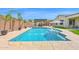 Sparkling pool with water features, complemented by lush landscaping and a charming pergola-covered dining area at 3842 E Fountain St, Mesa, AZ 85205