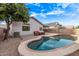 Backyard featuring a kidney shaped pool and an outdoor seating area at 3907 E Topeka Dr, Phoenix, AZ 85050