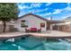 Backyard featuring a kidney shaped pool and an outdoor seating area at 3907 E Topeka Dr, Phoenix, AZ 85050