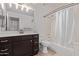 Neutral bathroom featuring a tub with shower, vanity with dark cabinets, and tiled floors at 3907 E Topeka Dr, Phoenix, AZ 85050