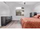 Bright bedroom featuring a large window, ceiling fan, and sleek, contemporary decor at 3907 E Topeka Dr, Phoenix, AZ 85050