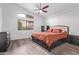 Comfortable bedroom with vaulted ceilings, a ceiling fan, and a large window for natural light at 3907 E Topeka Dr, Phoenix, AZ 85050