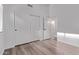 Bright bedroom featuring wood-look floors, closet with sliding doors, and a doorway to another room at 3907 E Topeka Dr, Phoenix, AZ 85050