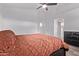 Inviting bedroom with a comfortable bed, ceiling fan, and minimalist decor at 3907 E Topeka Dr, Phoenix, AZ 85050