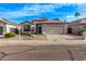 Street view showcasing a desert landscaped home with attached garages and a well maintained yard at 3907 E Topeka Dr, Phoenix, AZ 85050