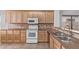 Well-equipped kitchen featuring light wood cabinetry, granite countertops, and modern appliances at 3907 E Topeka Dr, Phoenix, AZ 85050