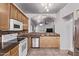 A kitchen featuring stainless steel appliances, wood cabinets, granite countertops, and tile floors at 3907 E Topeka Dr, Phoenix, AZ 85050